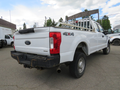 A white 2017 Ford F-250 Super Duty pickup truck with a ladder rack and a 4x4 badge on the side