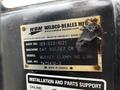 A metal identification plate from a Caterpillar 306 showing the model number and manufacturing information