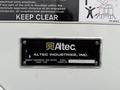 A metal nameplate displaying the logo and name of Altec Industries Inc along with information about utility equipment and a work order number