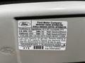 A 2013 Ford Econoline vehicle information label detailing engine specifications fuel type and fuel tank capacity