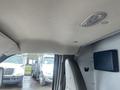 Interior view of a 2016 Chevrolet Express with a light fixture on the ceiling and gray upholstery on the driver seat