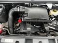 Engine compartment of a 2021 Mercedes-Benz Sprinter featuring a black air filter box and surrounding components