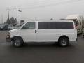 A white 2011 Chevrolet Express van parked with a sliding side door and chrome wheels