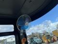 A small battery-operated fan mounted inside a vehicle cabin designed for comfort during operation