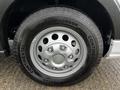 Close-up of a silver wheel with a multi-spoke design fitted on a 2021 Ford Transit tire marked with the brand name Continental and the model Vanco Four Season