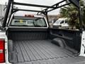 A 2018 GMC Sierra 1500 truck bed with a liner and black metal roof rack visible above it