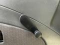 A black manual window crank handle mounted on the interior door panel of a 2013 International 7400