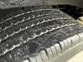 Close-up of a tire from a 2014 GMC Savana showing tread patterns and surface details