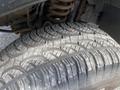 Close-up of a worn tire on a 2007 Ford F-350 SD showing visible tread patterns and signs of use