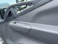 Interior door panel of a 2008 Mitsubishi Fuso FE180 with a grey finish and a handle on the side
