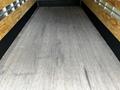 Interior of a 2018 Isuzu NPR truck featuring a wooden floor with visible wear and a simple, open cargo space