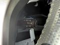 Close-up of a steering wheel control stalk from a 2015 Toyota Tacoma featuring buttons for cruise control settings including resume and set