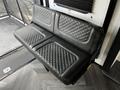 A black leather bench seat with diamond stitching in a recreational vehicle