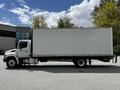 A white 2020 Hino 338 box truck with a blank cargo area and a flatbed is shown from the side in an outdoor setting
