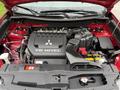 A 2016 Mitsubishi Outlander engine with a V6 MIVEC cover and various components including air intake and battery visible