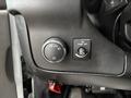 Dashboard controls of a 2020 Chevrolet Express featuring a headlight switch and a dome light control button