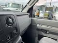 Interior view of a 2009 Ford Econoline showing the dashboard controls and steering area