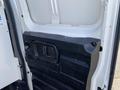 Interior side of a 2012 GMC Savana van showing a black panel with a door handle and textured surface