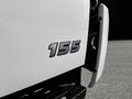 Close-up of the number 155 badge on a white 2020 Hino 155 truck