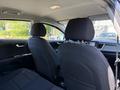 Interior of a 2018 Kia Rio5 showing two front seats with fabric upholstery and dashboard controls visible in the foreground