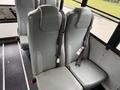 A row of gray bus seats with adjustable seat belts in a 2016 International CE300