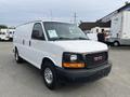 A white 2012 GMC Savana cargo van with a black grille and chrome wheels parked in a lot