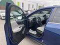 A blue 2022 Chevrolet Equinox with an open driver's door showing the interior and dashboard