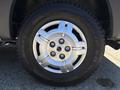 Close-up of a silver alloy wheel on a 2016 RAM Promaster featuring five spokes and a black tire with visible tread patterns