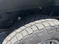 Close-up of the tire of a 2016 Ford F-150 showing the tread pattern and metallic wheel rim