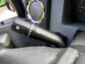 Close-up of a 2016 Ford F-550 steering column with a control stalk featuring turn signal and headlight settings