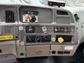 Dashboard of a 2006 Sterling L7500 featuring various control buttons gauges and switches including PTO controls and a diesel fuel indicator