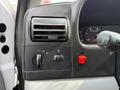 Close-up of the control panel of a 2007 Ford F-450 showing air conditioning vents switches and a red power button