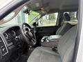 Interior of a 2016 RAM 1500 showing the driver's seat and center console with cup holders and dashboard instruments visible