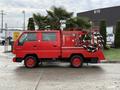 A red 2001 Toyota Dyna fire truck with a water tank and hose system mounted on the back, featuring a compact design and multiple compartments for firefighting equipment
