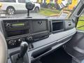 Dashboard of a 2012 Mitsubishi Fuso FE featuring a radio control panel and air conditioning dials