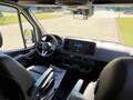 Interior view of a 2023 Mercedes-Benz Sprinter showing the driver's seat steering wheel dashboard and infotainment system