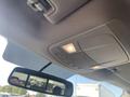 Overhead console of a 2017 Ford F-150 featuring buttons for lights and controls with a reflective rearview mirror below