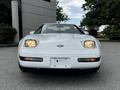 A 1992 Chevrolet Corvette in white with rounded headlights and a distinctive front grille