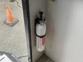 A fire extinguisher mounted on the wall of a camper trailer