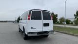 A white 2017 Chevrolet Express Quigley 4x4 van with a rear view showing its large back windows and distinctive taillights