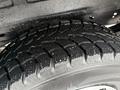 Close-up of a tire on a 2006 Ford Econoline showing deep tread patterns and slight dirt particles on the surface