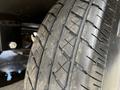 Close-up of a tire from a 2022 Heartland Torque showing detailed tread patterns and slight wear on the rubber surface
