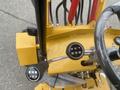 A close-up view of the control panel of a 2024 AGT KRW 23 Mini loader featuring levers and knobs for operation