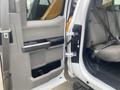 The image shows the open door of a 2017 Ford F-550 with a gray interior featuring a bench seat and seatbelt visible