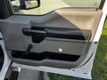 The image shows the interior door panel of a 2018 Ford F-550 featuring a gray and black design with a door handle and a lever for controlling the window