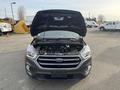 A 2019 Ford Escape with its hood raised showing the engine compartment and front grille