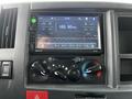 Dashboard of a 2022 Isuzu NPR featuring a car stereo display showing a radio frequency of 103.50 MHz with various knobs for tuning and volume control