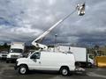 A 2008 Ford Econoline van with a white exterior equipped with a raised aerial work platform on top for utility and maintenance tasks