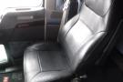 A black leather driver's seat from a 2015 Kenworth T660 truck with adjustable features and ergonomic design