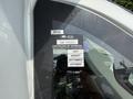 2020 Chevrolet Express with a certificate of approval sticker on the driver's side window displaying various months of expiration